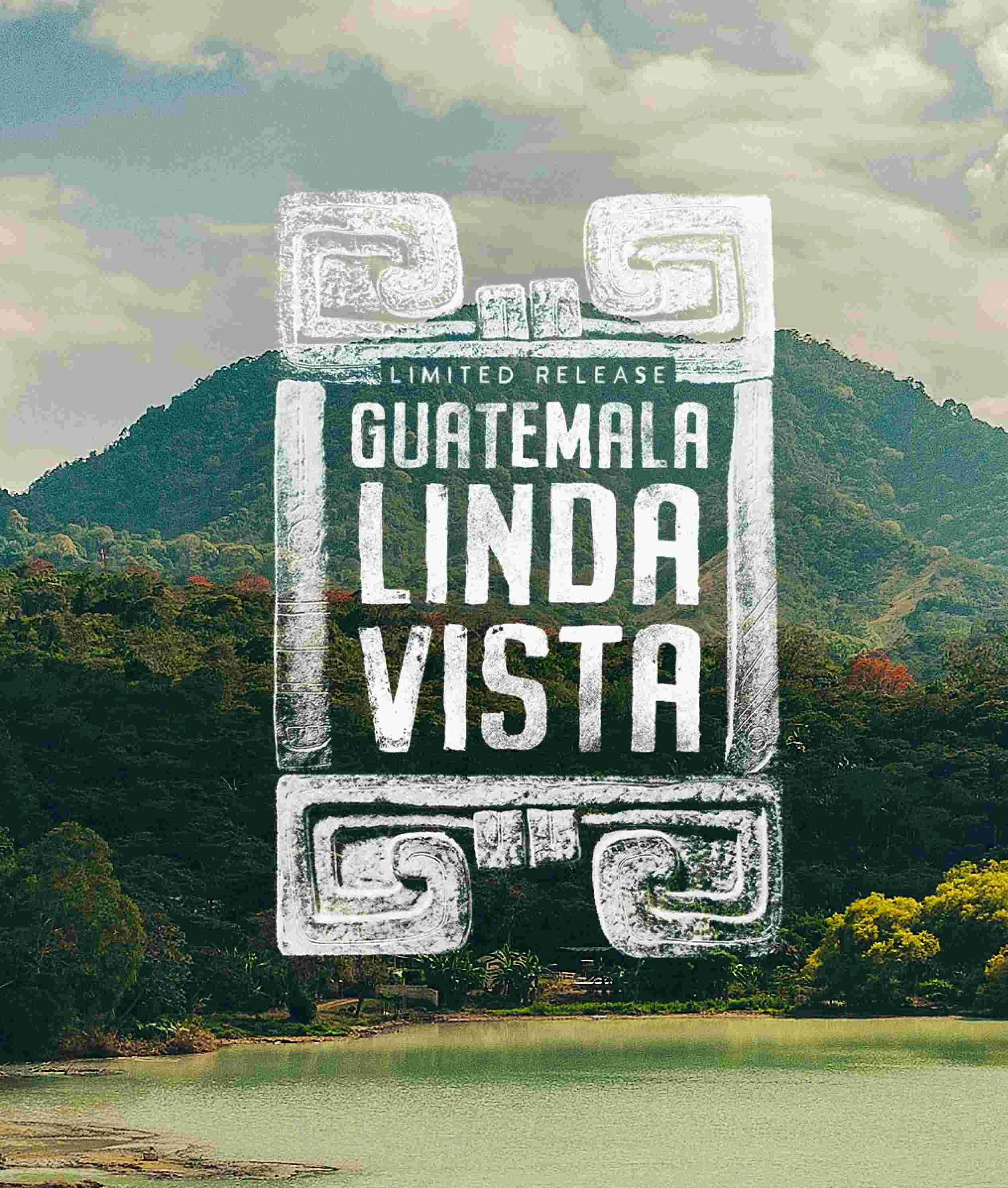 A scenic poster-style image showing a mountain, lake, and cloudy sky with a large central stone-like graphic reading 'GUATEMALA LINDA VISTA' and smaller text 'LIMITED RELEASE'. This appears to be the artwork itself rather than a photographed physical product in a studio or lifestyle setting, so Scenery fits best because the depicted landscape scene is the product being shown/sold as art or cover art.